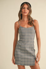 Load image into Gallery viewer, Woman wearing a plaid dress against a beige background
