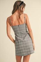 Load image into Gallery viewer, Woman wearing a gray plaid dress on a beige background

